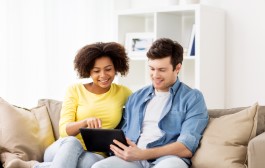 technology, internet and people concept - smiling happy couple with tablet pc computer at home
